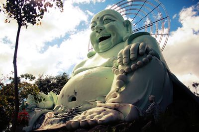 Low angle view of statue against cloudy sky