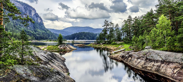 Panoramic view of river amidst mountains against sky