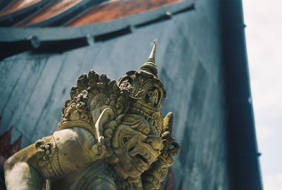Low angle view of statue against temple