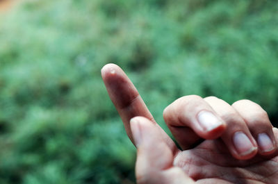 Close-up of water drop on human hand