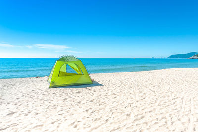 Scenic view of beach against blue sky