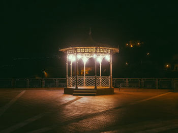Illuminated street light on footpath at night
