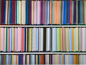 Colorful men clothes arranged in the row at the shop for sale