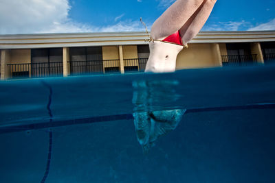 Midsection of woman in swimming pool