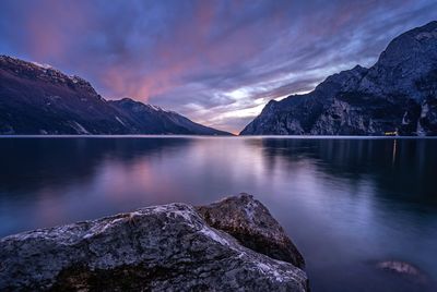 Scenic view of lake garda against sky during sunset