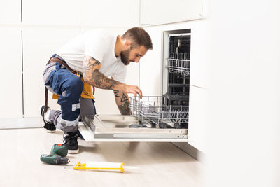 Side view of man working at home