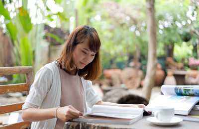 Young woman sitting on table