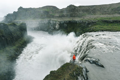 Scenic view of waterfall against sky