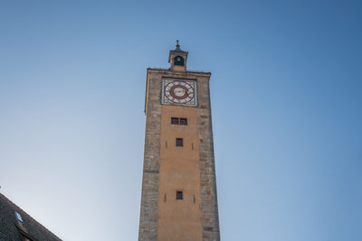 Low angle view of clock tower against clear blue sky