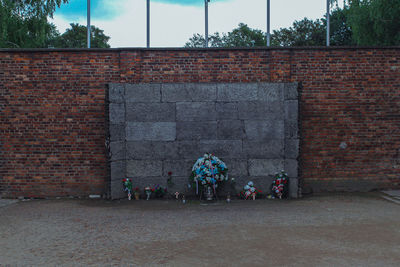 People walking on brick wall of building