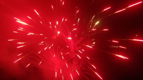 Low angle view of firework display at night