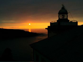 Silhouette of lighthouse at seaside