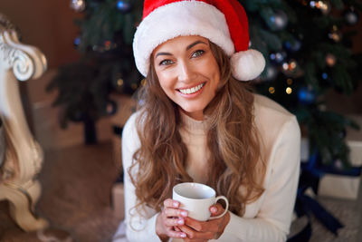 Portrait of young woman with coffee cup