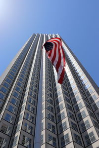 Low angle view of modern building against clear blue sky