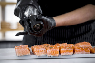 Cropped hand of person preparing food