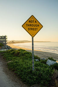 Information sign on road against clear sky