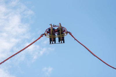 Low angle view of crane against sky