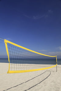 Scenic view of beach against blue sky