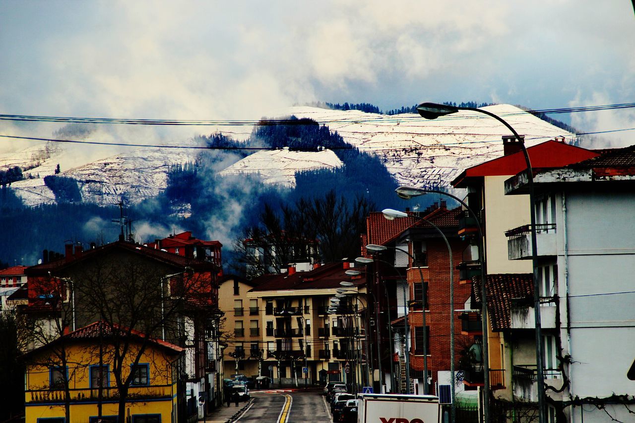 architecture, building exterior, built structure, snow, mountain, house, sky, winter, day, outdoors, no people, cold temperature, cloud - sky, residential building, nature, city, tree