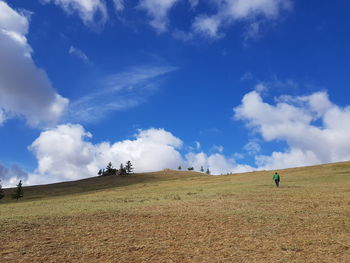 Scenic view of land against blue sky