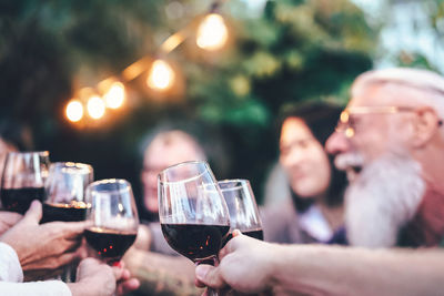 People toasting wineglasses during party