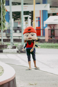 Side view of boy walking on street