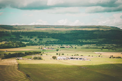 Scenic view of farm against sky