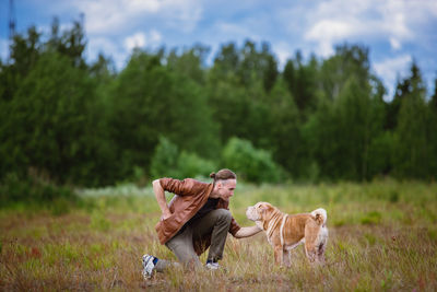 Man with dog in field
