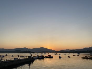 Boats in marina at sunset