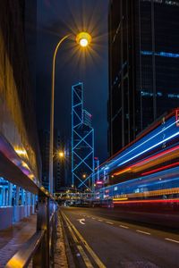 Light trails on road against sky at night