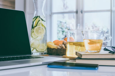 Morning time at home healthy breakfast laptop and phone on table. natural meal and drink at work