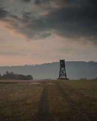 Lookout tower on land against sky