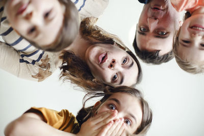 High angle view of mother and daughter against white background