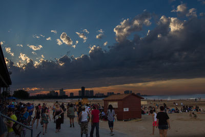 People at beach during sunset