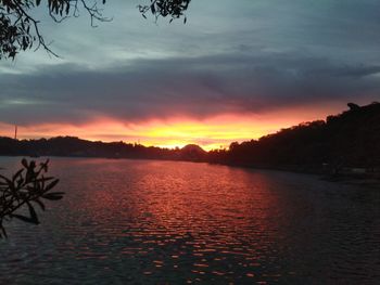 Scenic view of lake against romantic sky at sunset