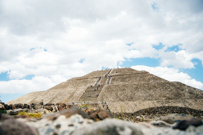 Low angle view of castle on mountain against sky