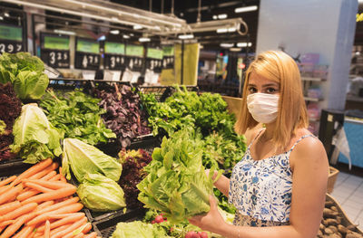 Portrait of woman wearing mask at vegetables market