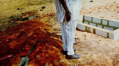 Low section of man standing on ground