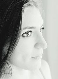 Close-up of young woman looking away at home