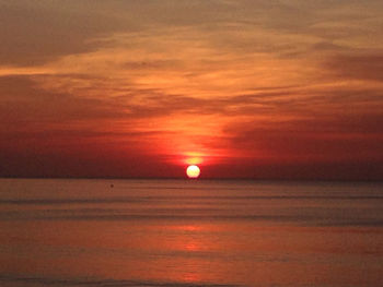 Scenic view of sea against romantic sky at sunset