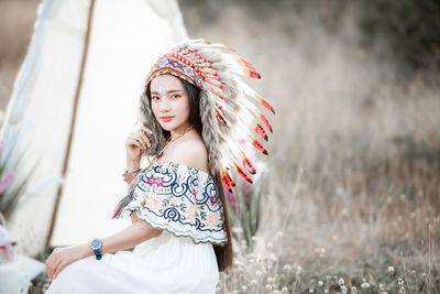 Boho bohemian girl styled wearing indian maxi dress and jewellery in autumn field