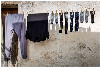 Clothes drying on clothesline against wall