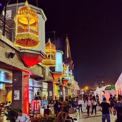 People in illuminated building at night