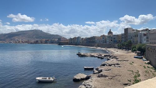 Panoramic view of sea and buildings against sky