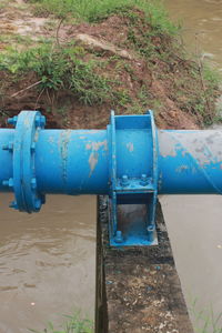 Blue water pipe on grass