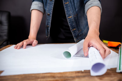 Midsection of man working on table