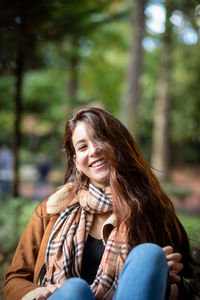 Portrait of smiling woman sitting outdoors