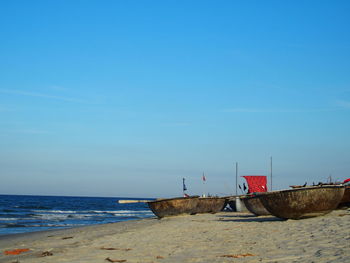 Scenic view of beach against blue sky