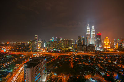 Aerial view of city lit up at night