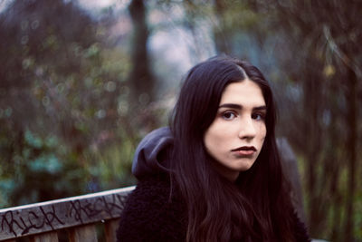 Portrait of beautiful young woman in forest